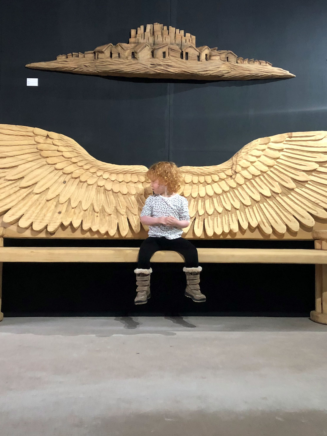 Angel wings carved wooden bench