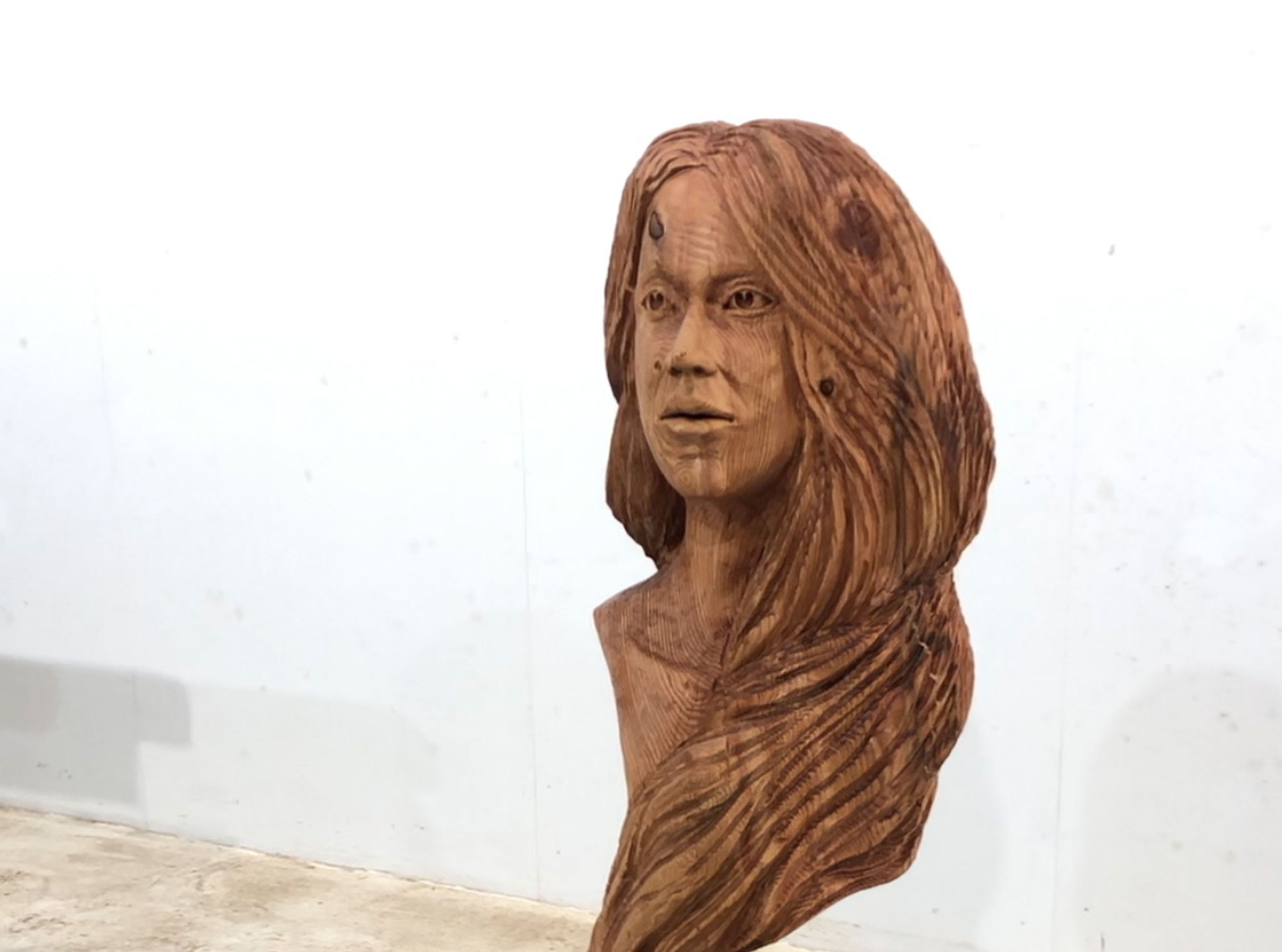 Girl's head , wooden carving by Matthew Crabb