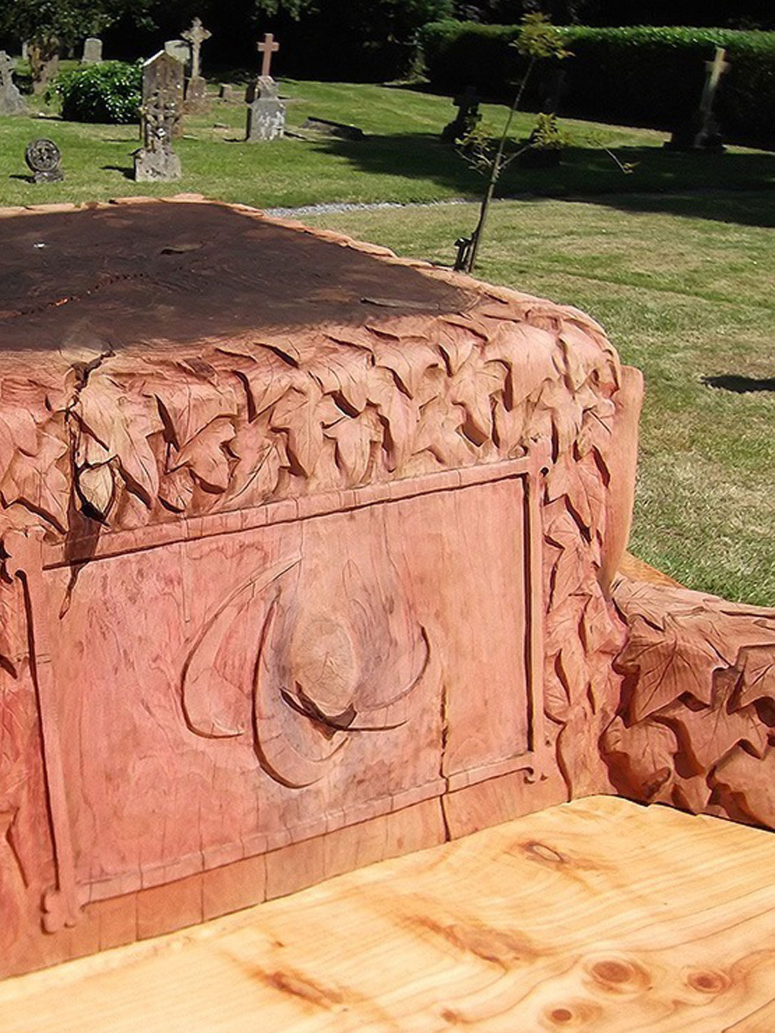 Carved wooden jubilee bench at Butleigh Church by Matthew Crabb