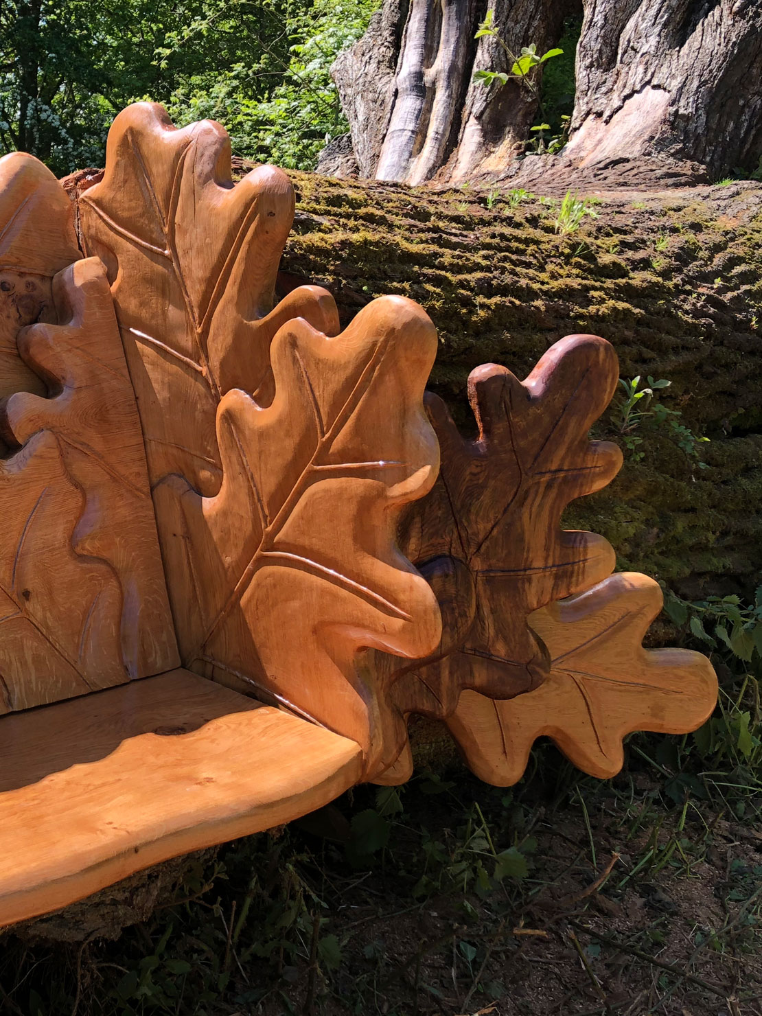 Carved oak bench with oak leaf design