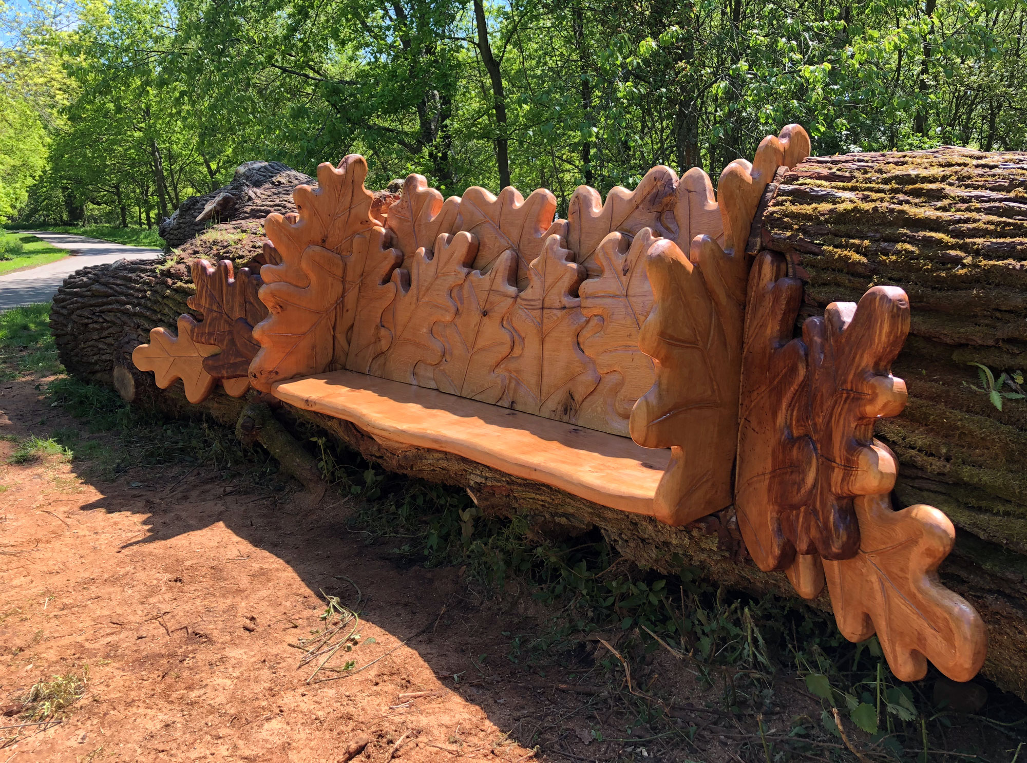 Carved oak bench with oak leaf design