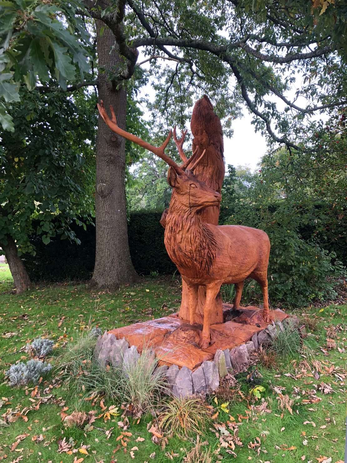 Wooden sculpture of a stag with an owl