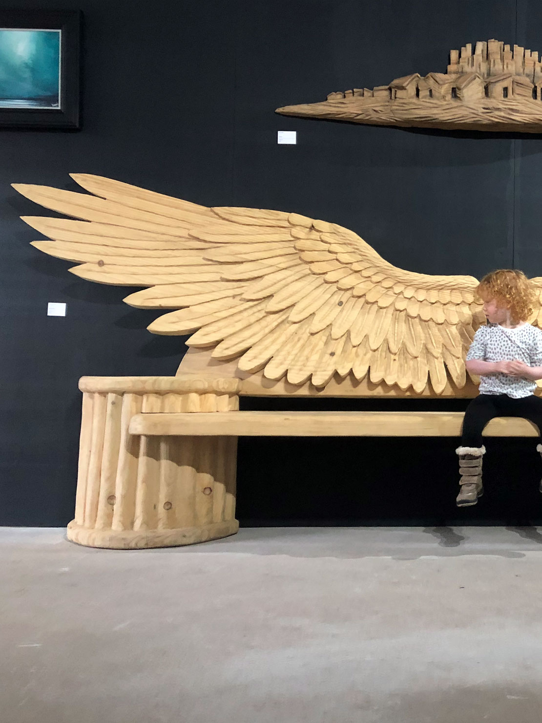 Angel wings carved wooden bench