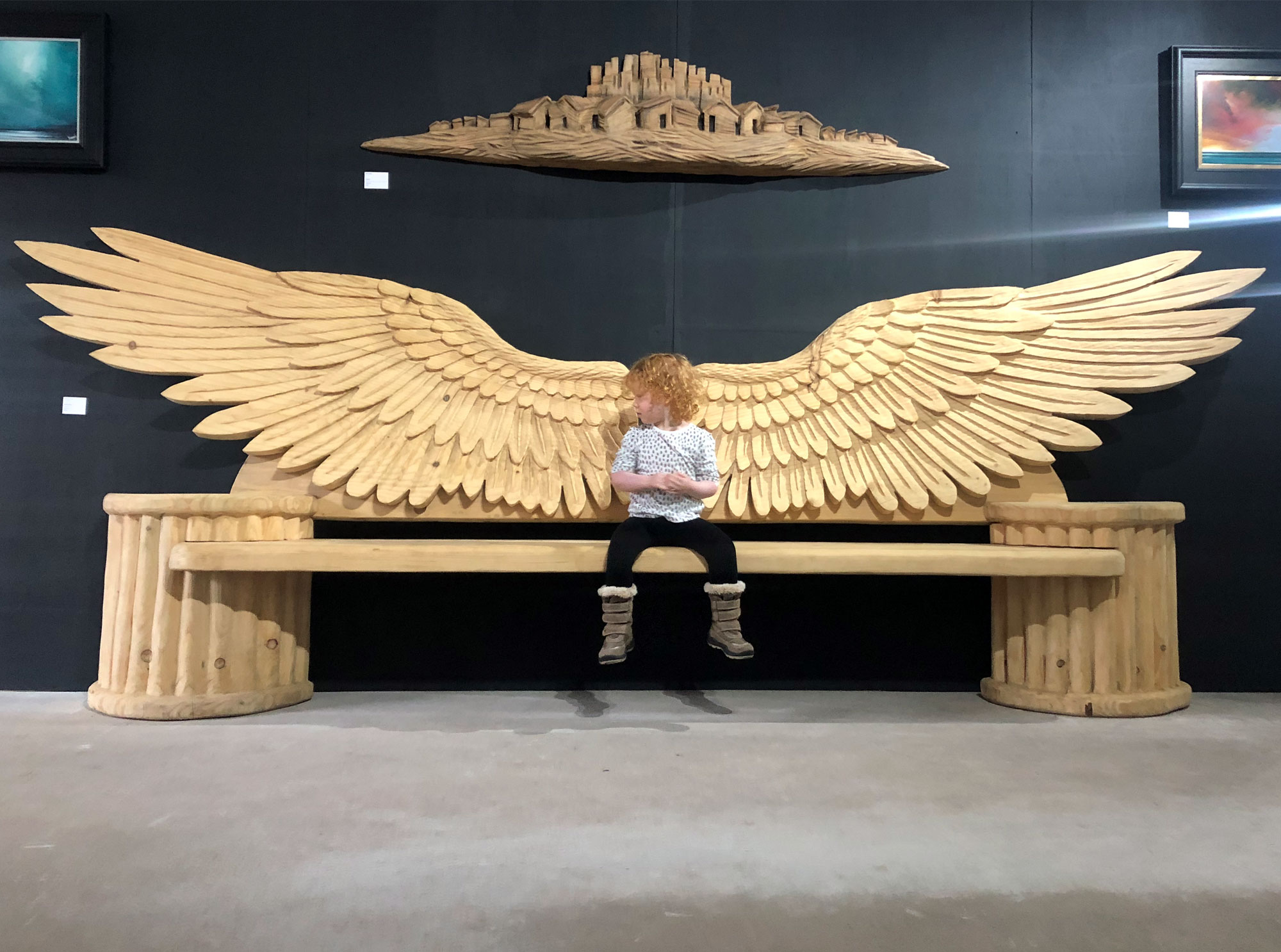 Angel wings carved wooden bench