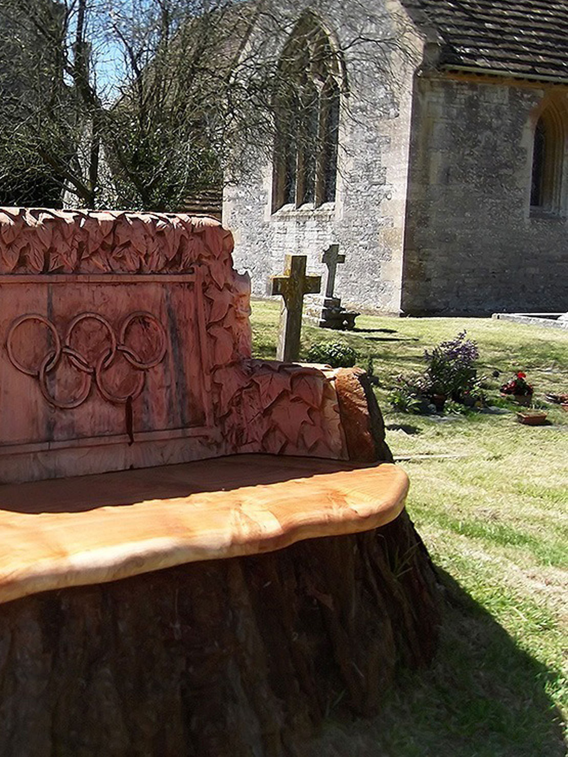 Carved wooden jubilee bench at Butleigh Church by Matthew Crabb
