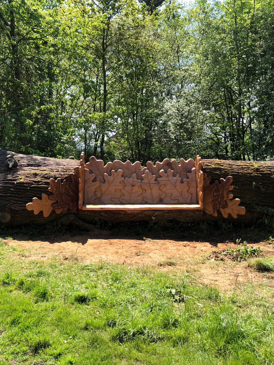Carved oak bench with oak leaf design