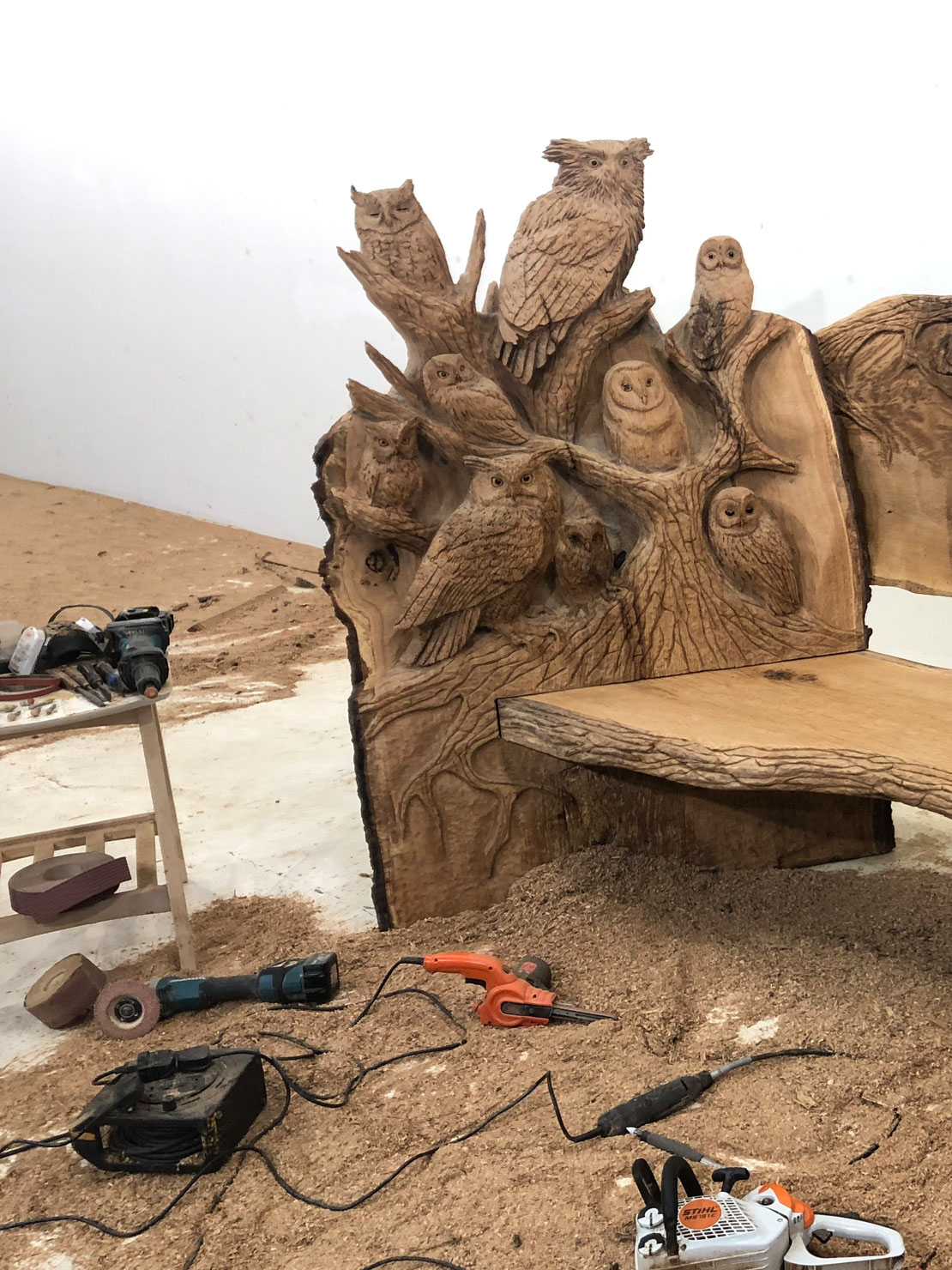 Carved wooden owl bench by Matthew Crabb