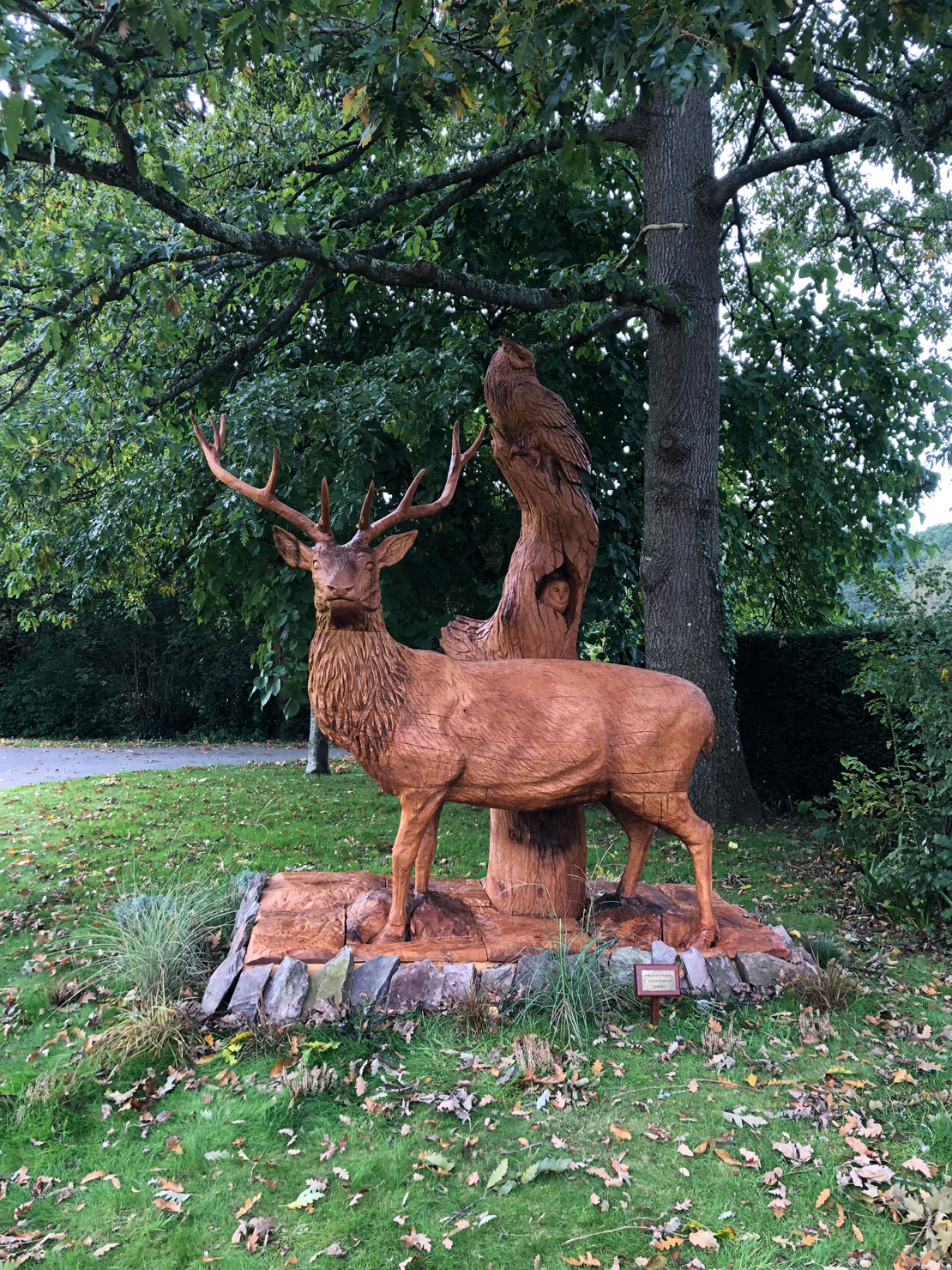 Wooden sculpture of a stag with an owl