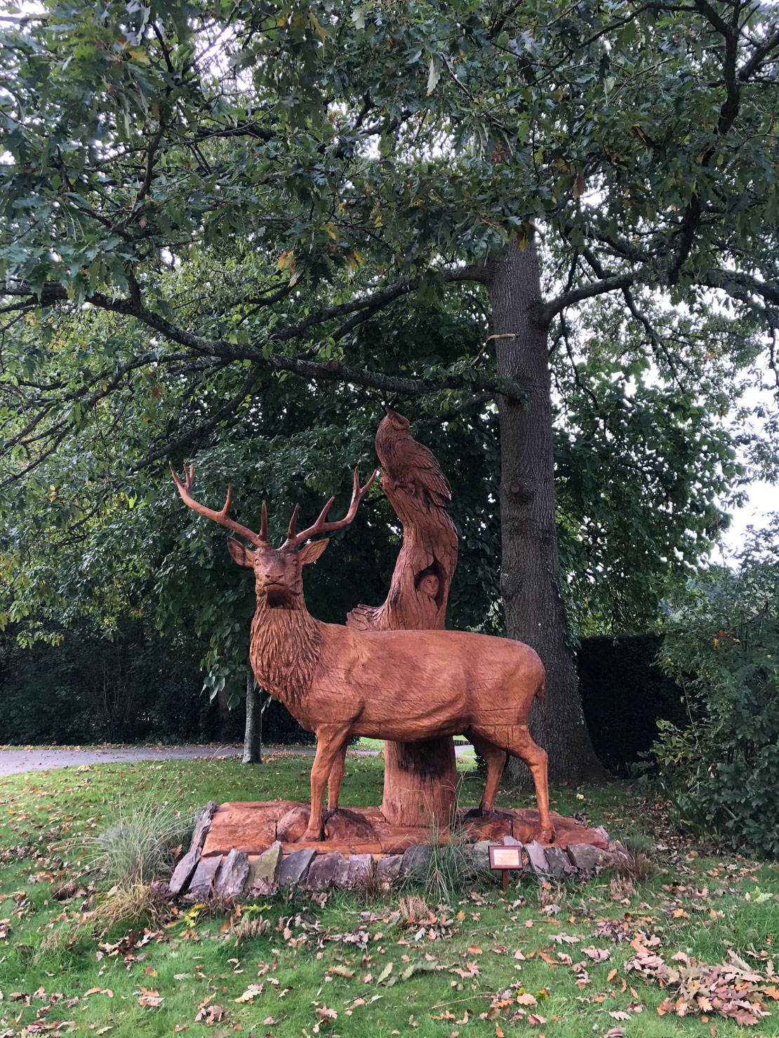 Wooden sculpture of a stag with an owl