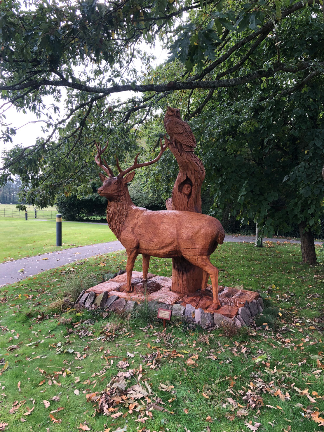 Wooden sculpture of a stag with an owl